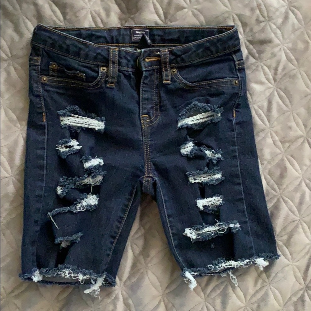 Ripped jean shorts .